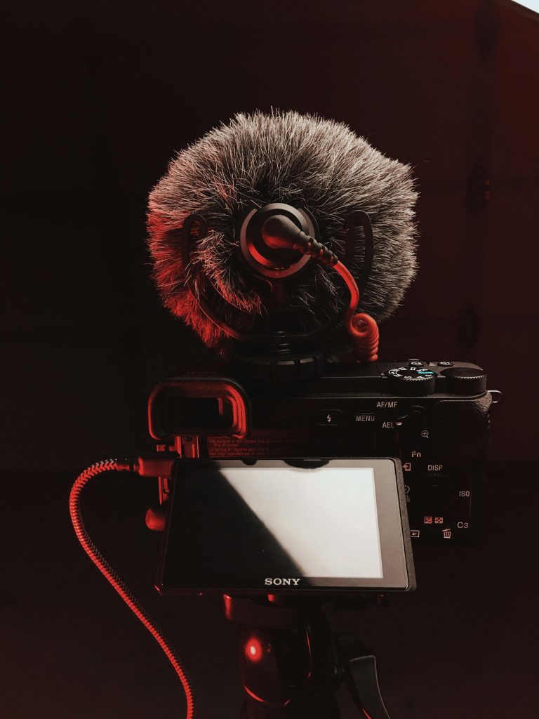 Close-up of a DSLR camera with a microphone, perfect for video and audio recording.
