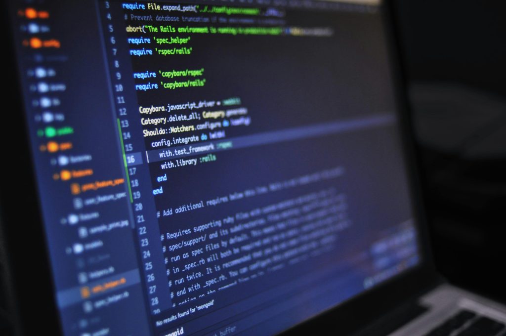 Home Close-up of a computer screen displaying programming code in a dark environment.